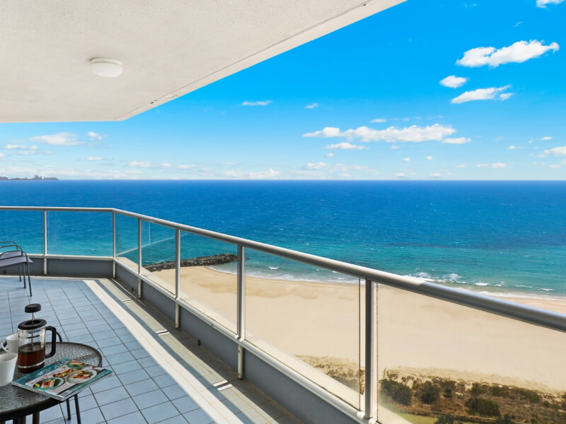 Ocean-view balcony from ULTIQA Points North overlooking the beach and turquoise water.