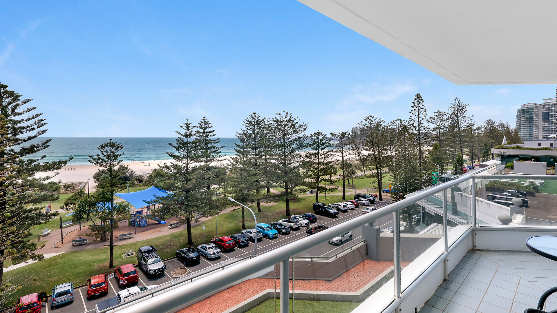 Balcony view from the Standard 2 Bedroom Centre Front Apartment at ULTIQA Points North, overlooking Coolangatta Beach and parklands.