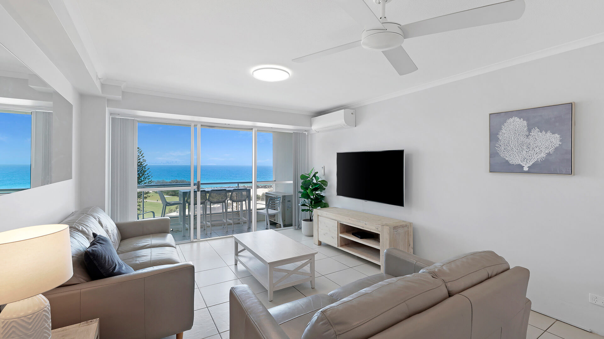 Bright living area of the Standard 2 Bedroom Centre Front Apartment at ULTIQA Points North, featuring ocean views from the private balcony.
