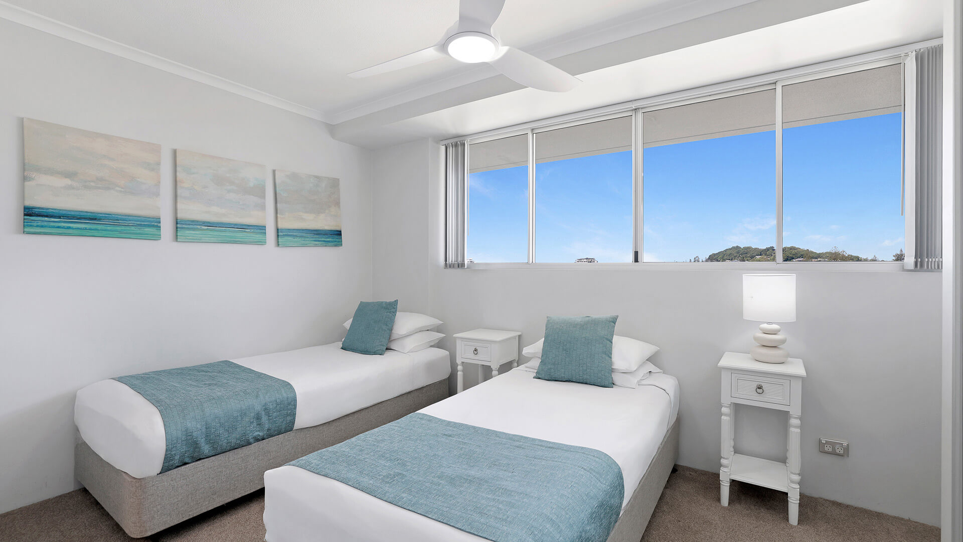 Twin bedroom in the Standard 2 Bedroom Centre Front Apartment at ULTIQA Points North, with natural light and coastal décor.