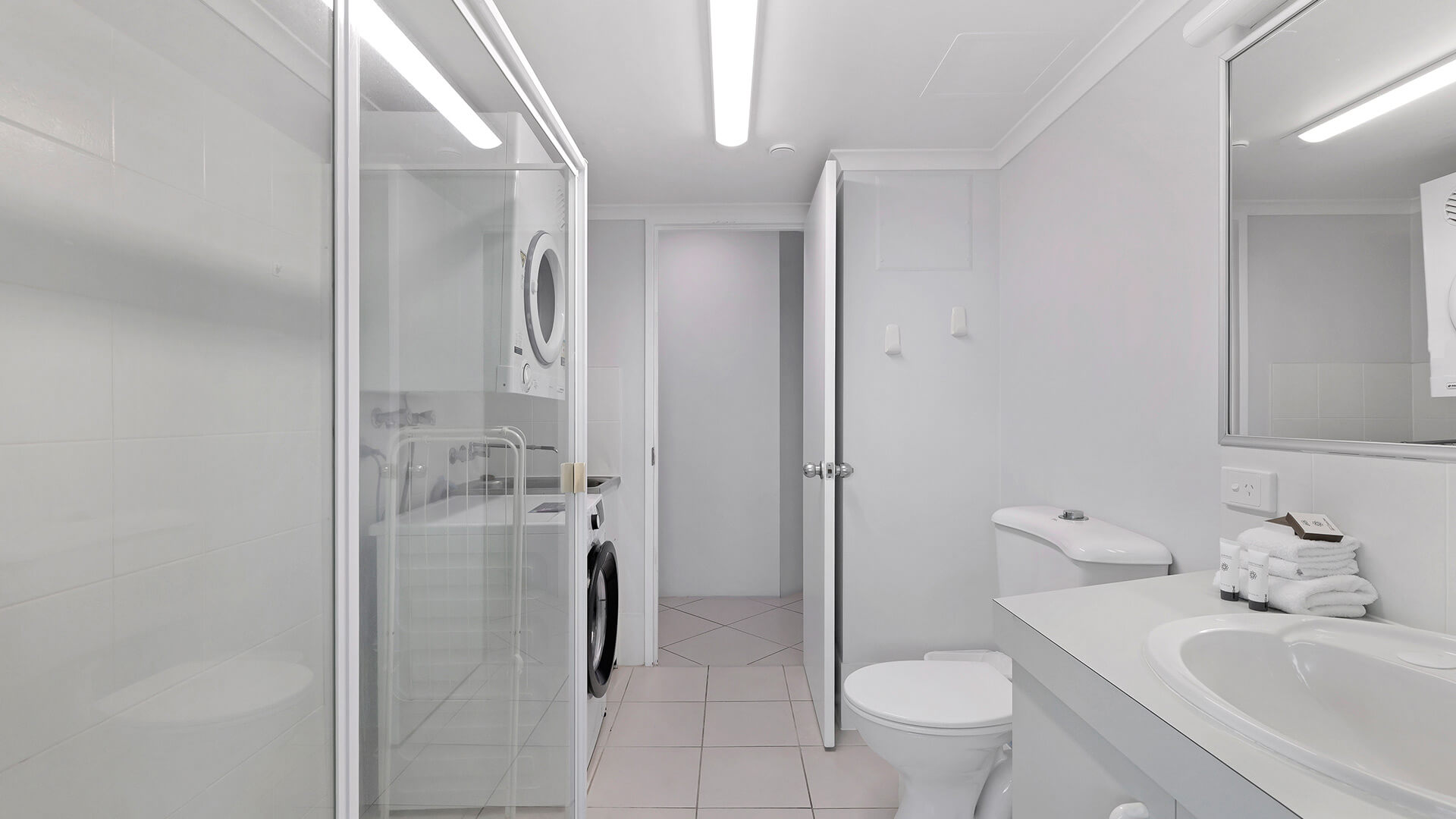 Second bathroom in the Standard 2 Bedroom Centre Front Apartment at ULTIQA Points North, featuring a shower and laundry facilities.