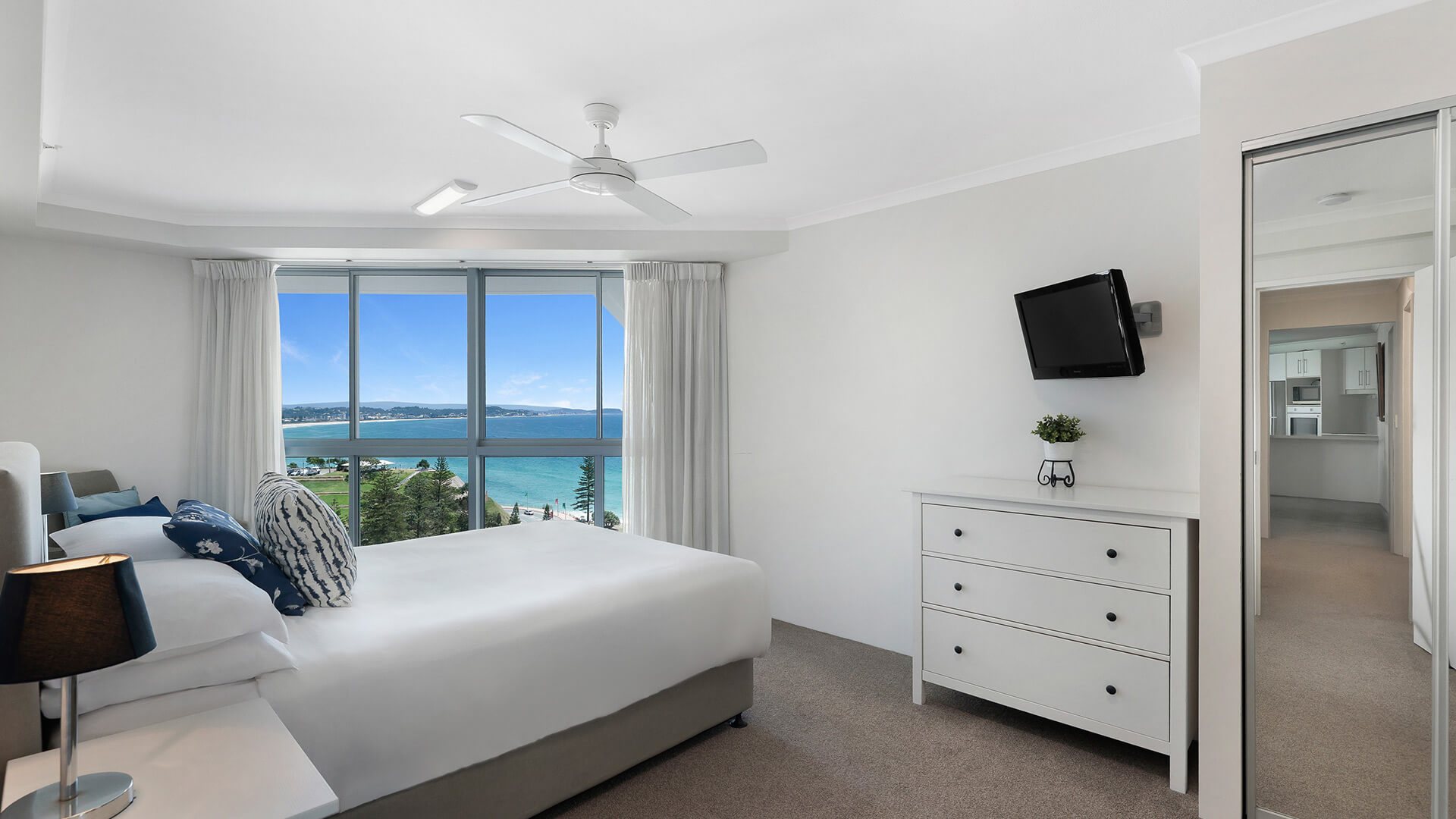 Master bedroom in the Superior 2 Bedroom Ocean View Apartment at ULTIQA Points North, featuring stunning ocean and coastline views.