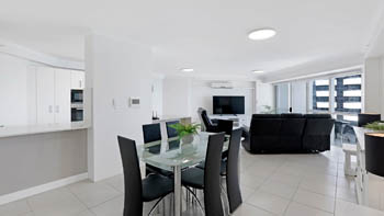 Modern white kitchen in the 2 Bedroom Superior Ocean View Apartment featuring ample cabinetry, tiled floors, and full appliances.