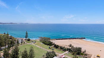 Ocean and beach views from the 2 Bedroom Superior Ocean View Apartment, overlooking parkland, turquoise water, and the coastline.